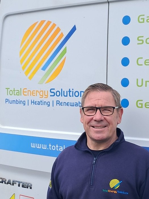 Stuart, founder of Total Energy Solutions Scotland Limited, in front of a company van
